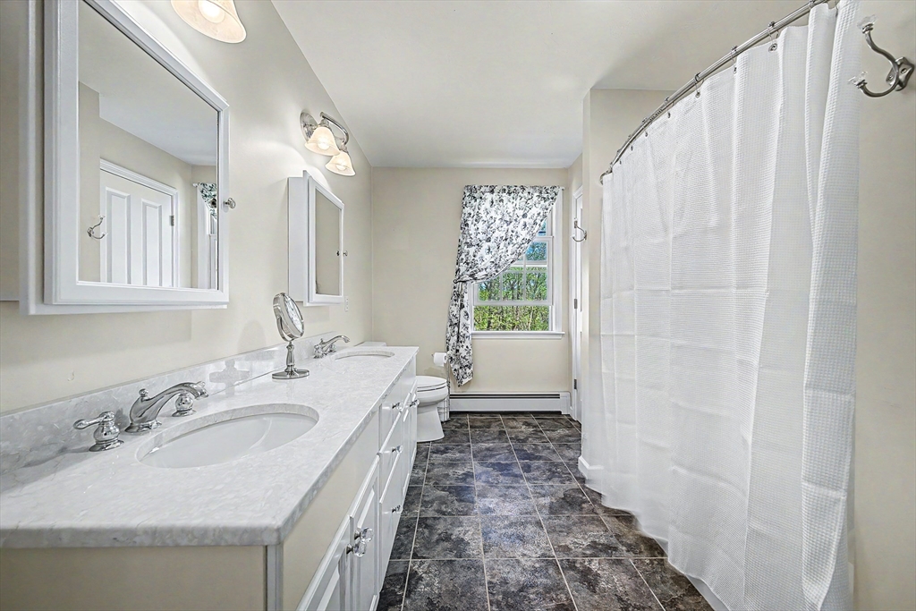 270 Mendon Road Sutton, MA 01590 - Photo 30 of 42 a bathroom with a sink a vanity and a mirror