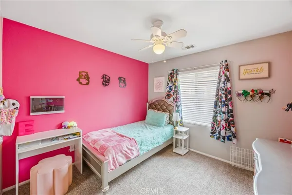 a bedroom with furniture and flat screen tv