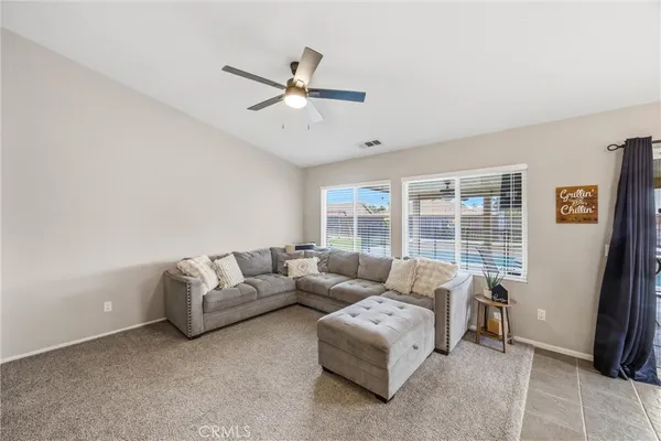 a living room with furniture tv and a fireplace