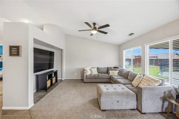 a living room with furniture and a large window