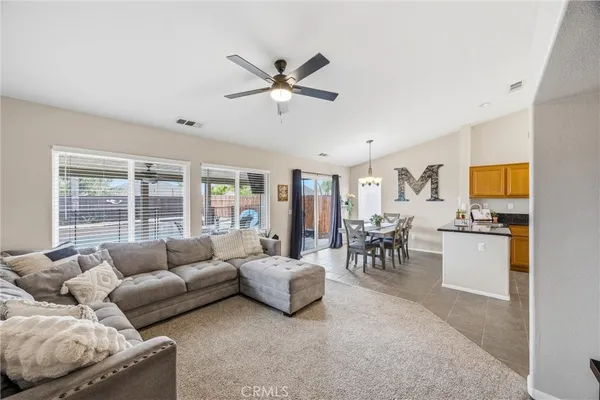 a kitchen with stainless steel appliances granite countertop a sink a stove and refrigerator