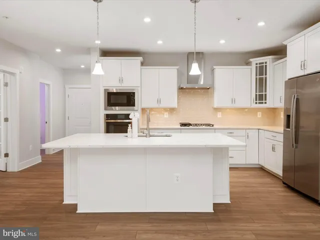 a view of an empty room with a kitchen