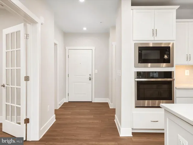 a large kitchen with stainless steel appliances kitchen island granite countertop a stove a sink a refrigerator and a microwave