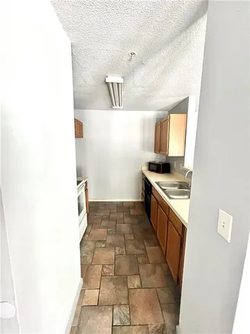 a kitchen with a sink and a stove
