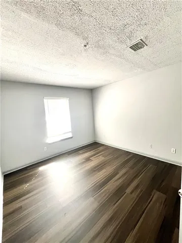 a view of an empty room and wooden floor