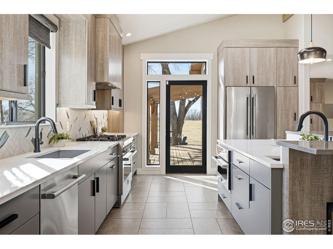 12212 Cash Road Longmont, CO 80503 - Photo 12 of 47 a kitchen with a sink and cabinets