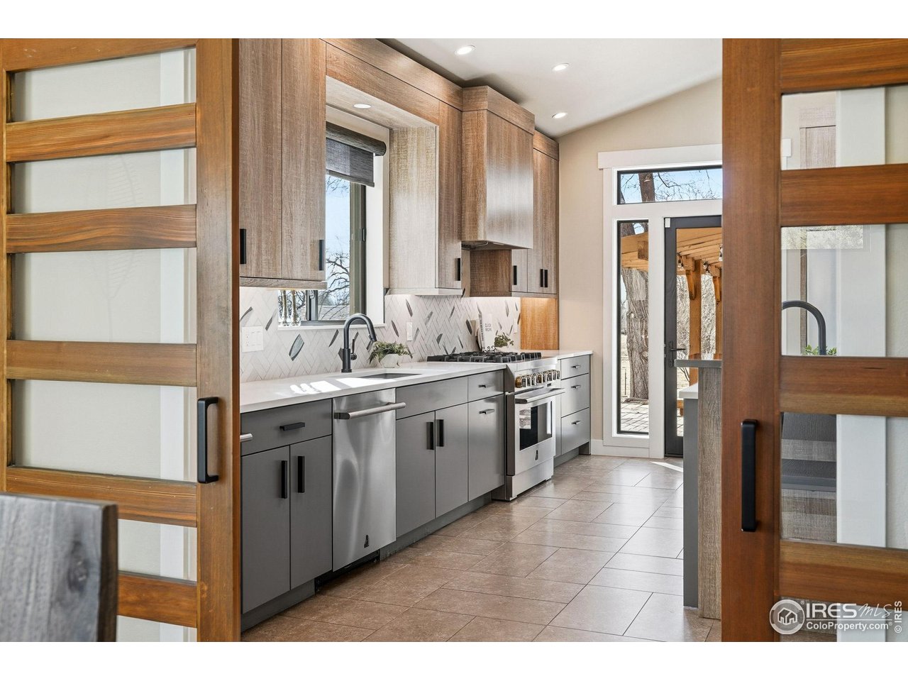 12212 Cash Road Longmont, CO 80503 - Photo 15 of 47 a kitchen with stainless steel appliances granite countertop a sink and cabinets