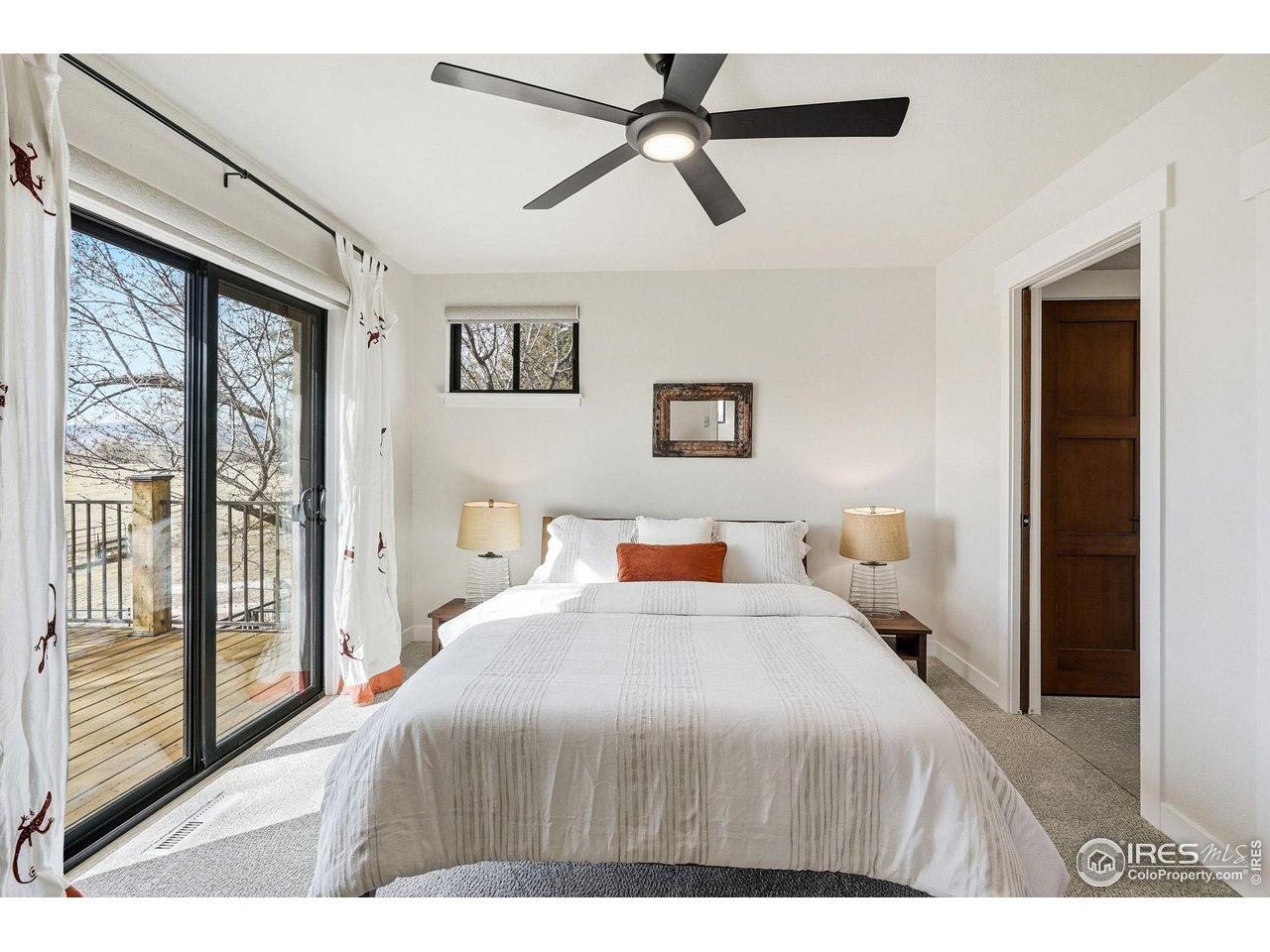 12212 Cash Road Longmont, CO 80503 - Photo 22 of 47 a bedroom with a large bed and a chandelier