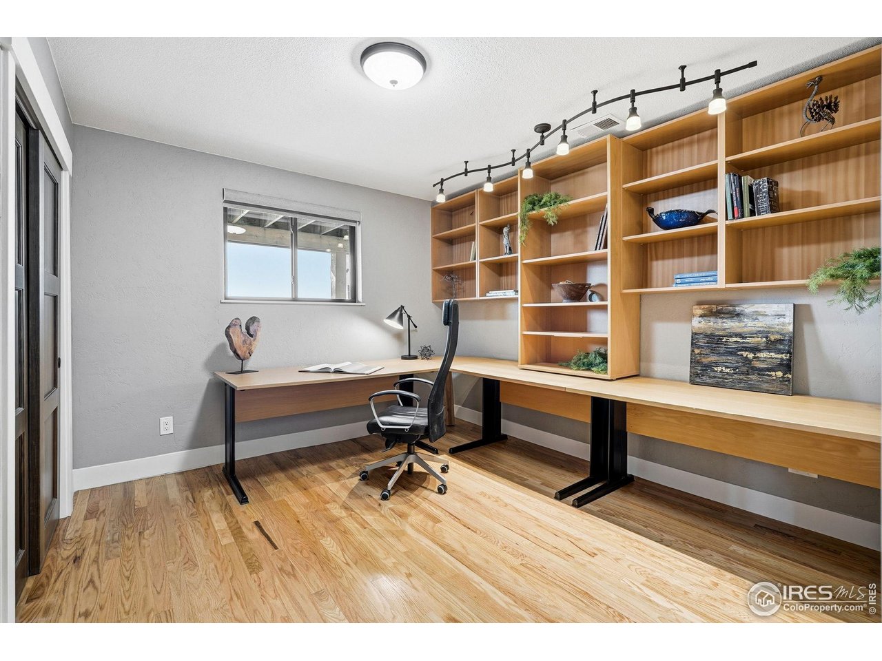 12212 Cash Road Longmont, CO 80503 - Photo 28 of 47 a living room with a couch and a bookshelf