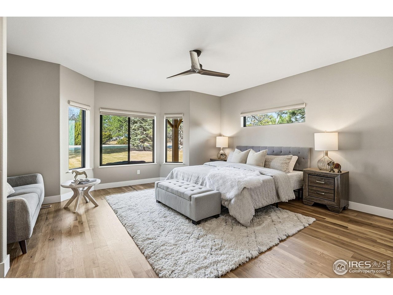 12212 Cash Road Longmont, CO 80503 - Photo 3 of 47 a bedroom with a large bed and a chandelier