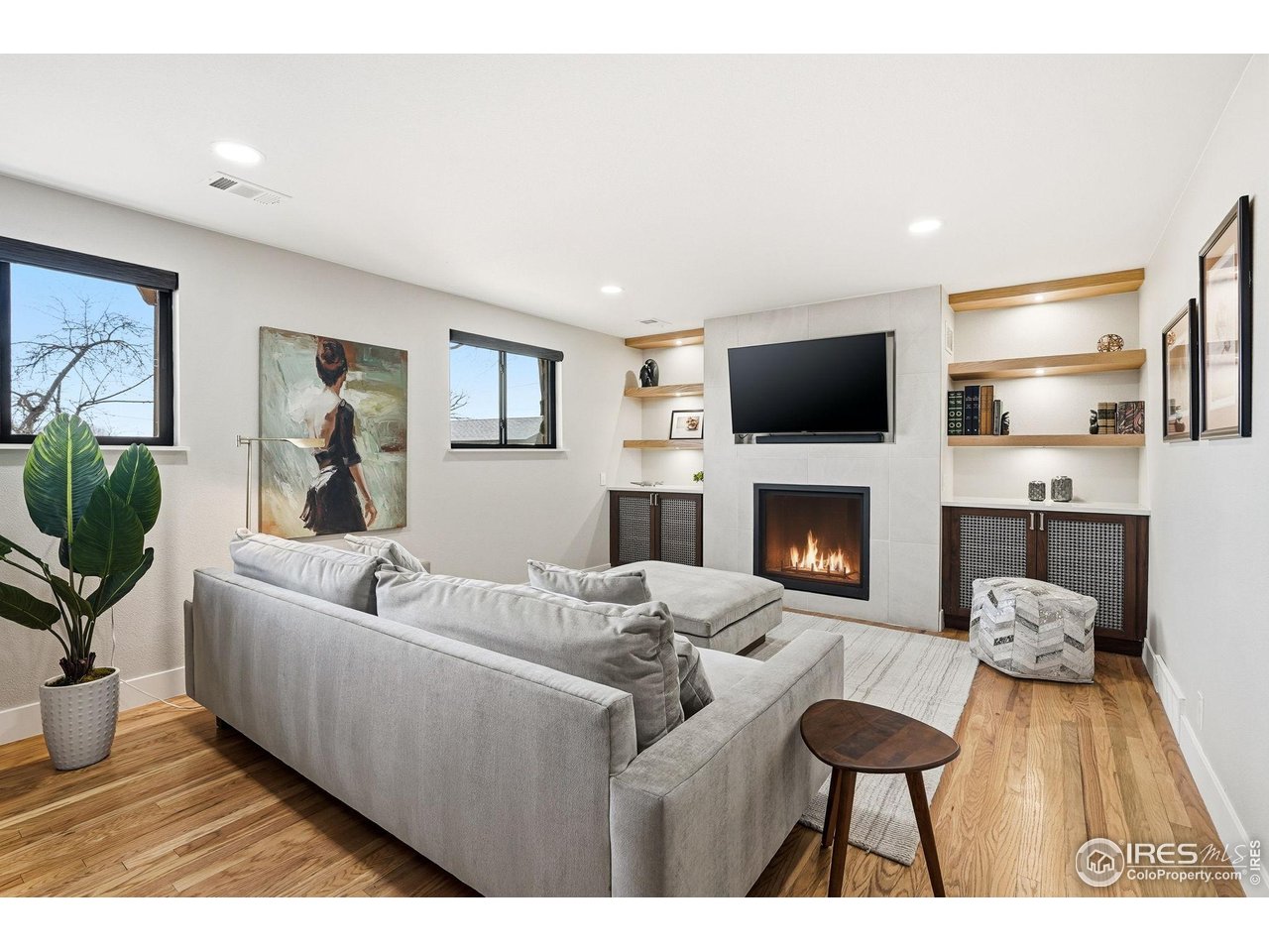12212 Cash Road Longmont, CO 80503 - Photo 30 of 47 a living room with furniture a flat screen tv and a fireplace