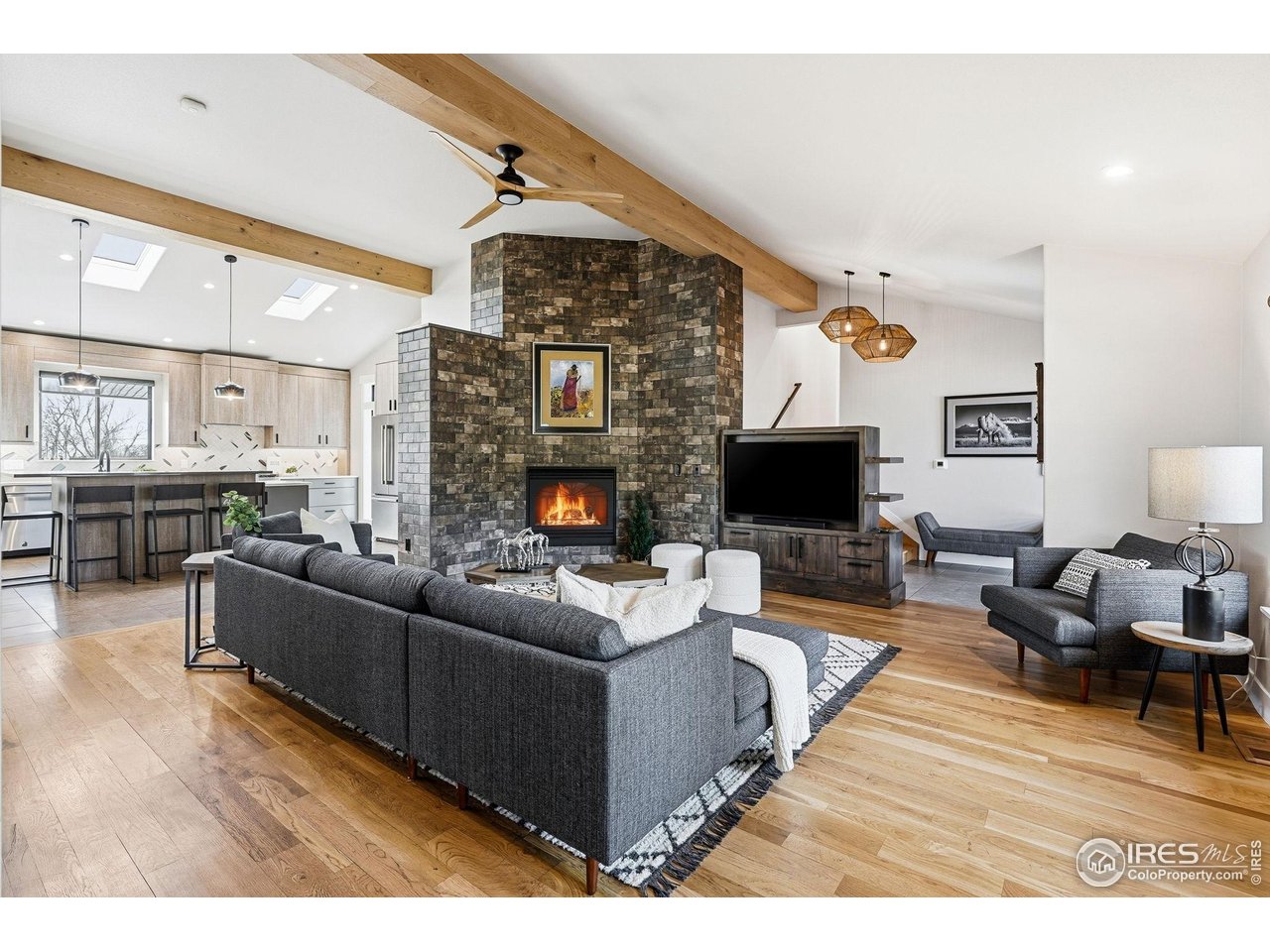 12212 Cash Road Longmont, CO 80503 - Photo 9 of 47 a living room with furniture wooden floor and a fireplace