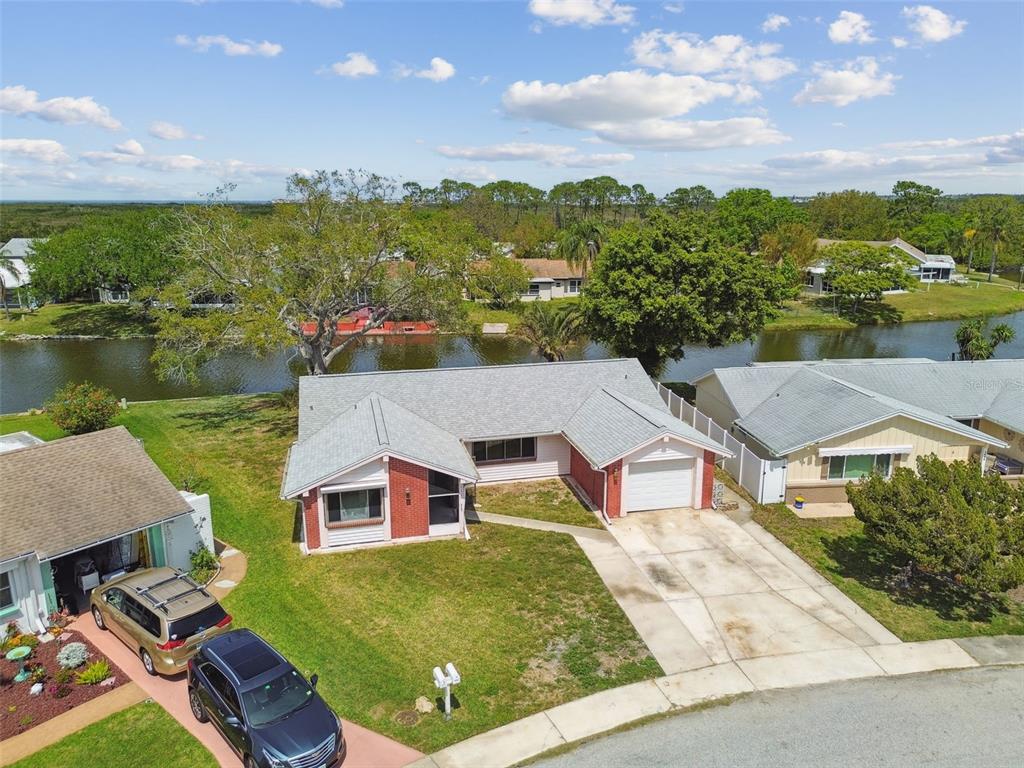an aerial view of residential houses with outdoor space and swimming pool