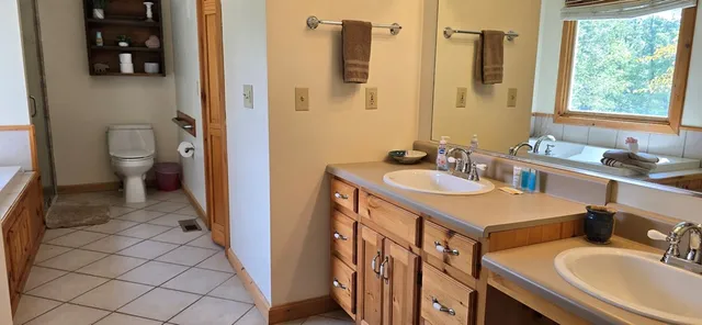a bathroom with a sink toilet and mirror
