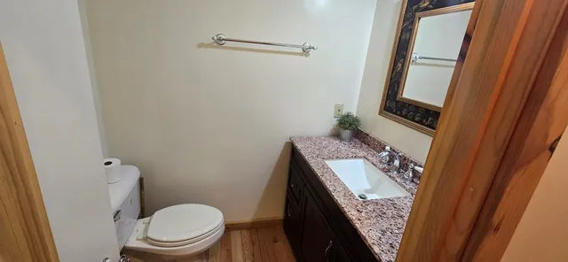 a bathroom with a granite countertop sink toilet and shower