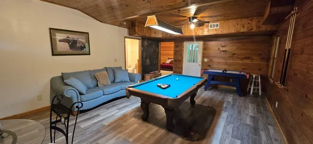 a living room with furniture a table and a potted plant