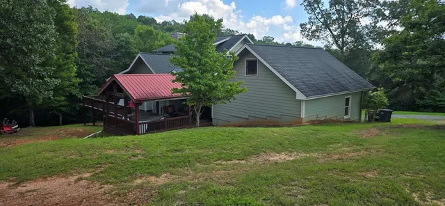 a aerial view of a house with table and chairs in the yard