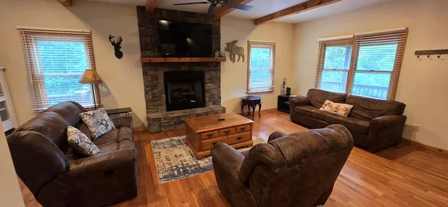 a living room with furniture fireplace and flat screen tv