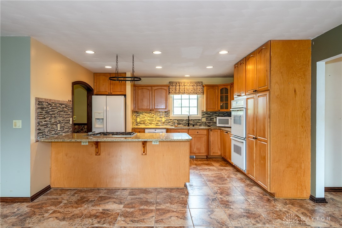 9981 Ridge Acres Lane Englewood, OH 45322 - Photo 11 of 73 This spacious kitchen offers a blend of functionality and style, ideal for any culinary enthusiast.