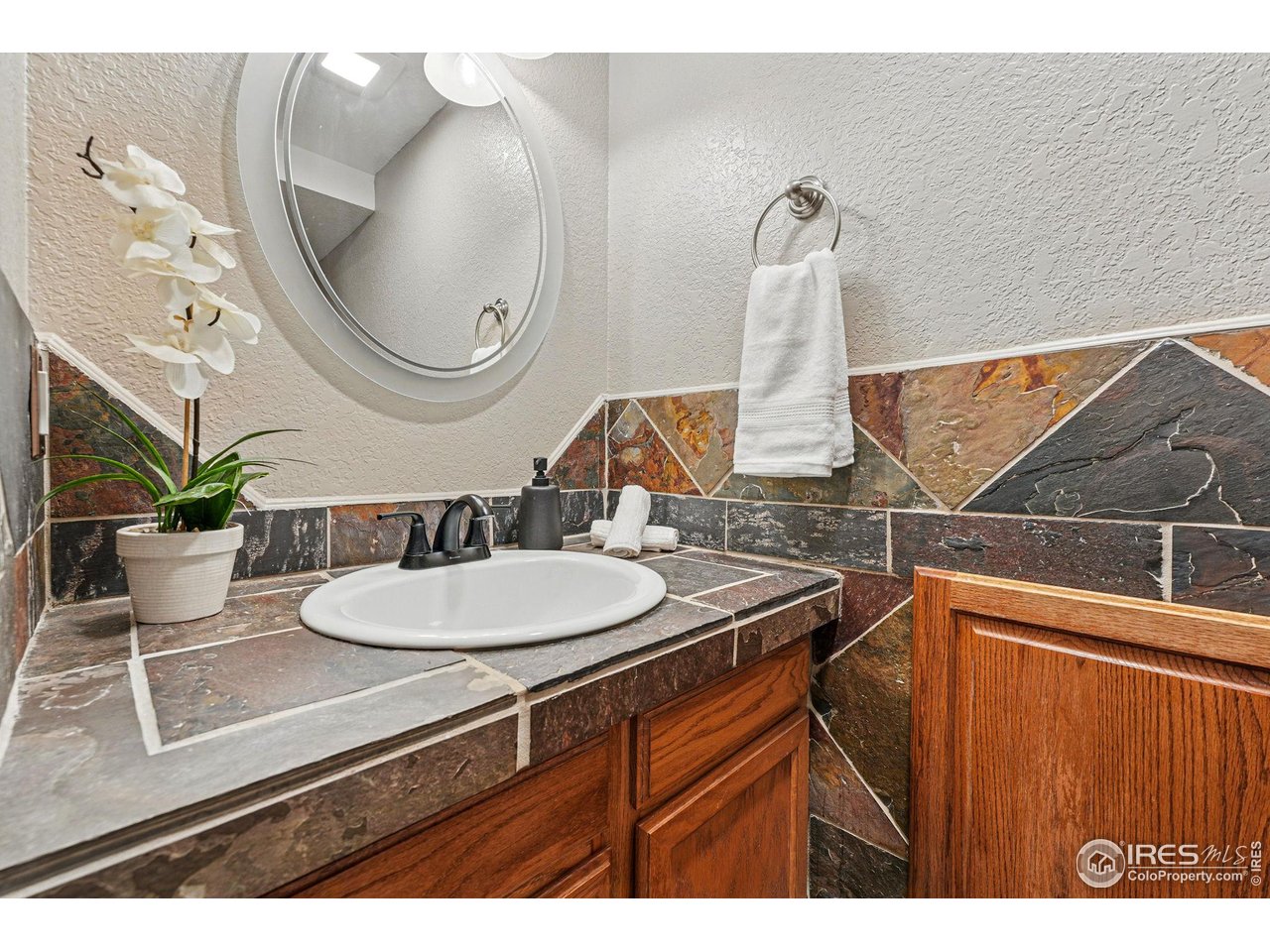5016 Buckingham Road, Unit 4 Boulder, CO 80301 - Photo 9 of 22 a bathroom with a sink and a mirror