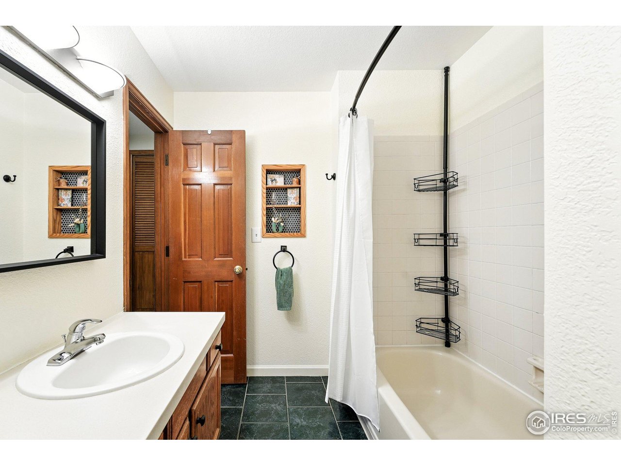 5016 Buckingham Road, Unit 4 Boulder, CO 80301 - Photo 16 of 22 a bathroom with a sink a shower and a mirror