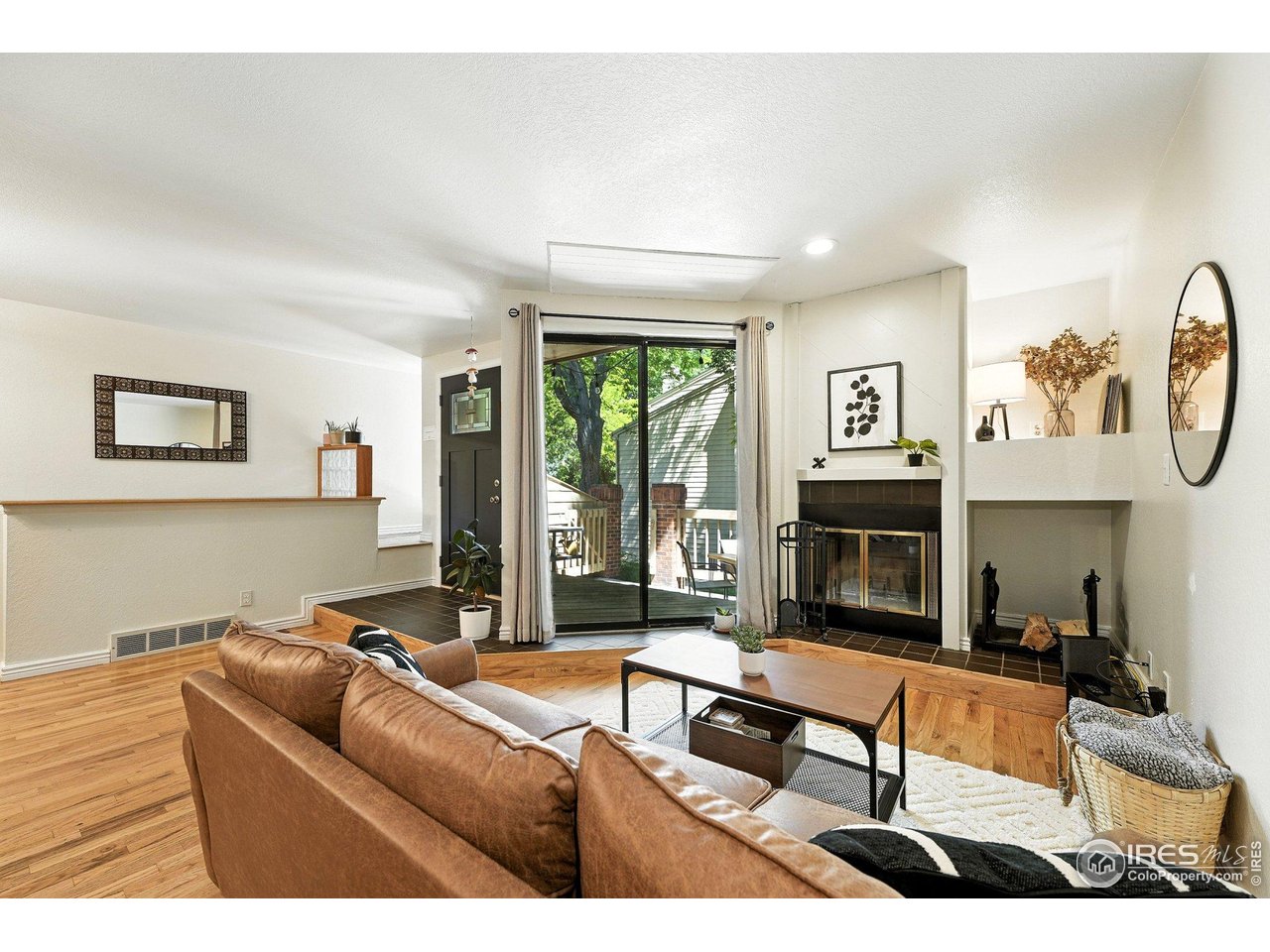 5016 Buckingham Road, Unit 4 Boulder, CO 80301 - Photo 3 of 22 a living room with furniture a large window and a fireplace