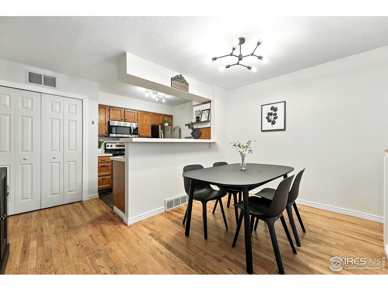 5016 Buckingham Road, Unit 4 Boulder, CO 80301 - Photo 22 of 22 a view of a dining room with furniture and wooden floor