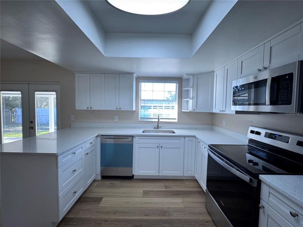 2527 Ridge Top Way Valrico, FL 33594 - Photo 15 of 31 a large kitchen with stainless steel appliances granite countertop a sink dishwasher a stove and a microwave oven with cabinets