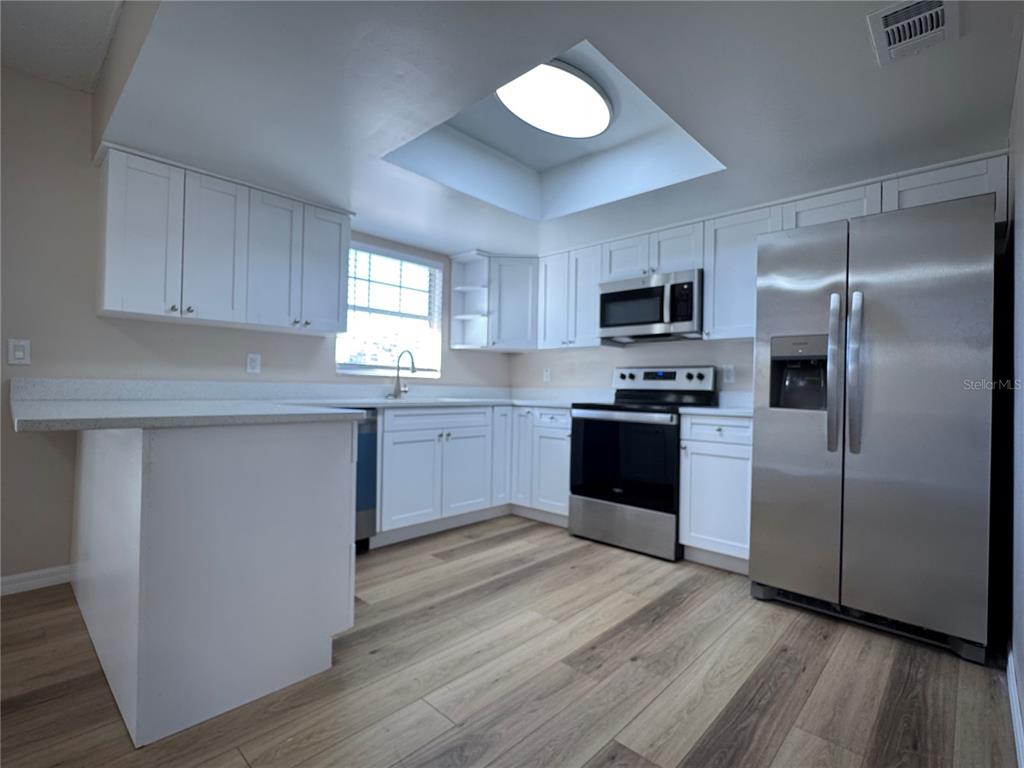 2527 Ridge Top Way Valrico, FL 33594 - Photo 16 of 31 a kitchen with granite countertop a refrigerator and a stove top oven
