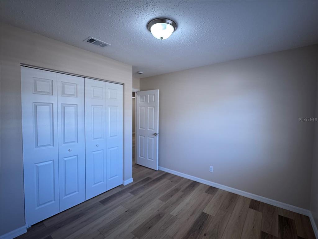 2527 Ridge Top Way Valrico, FL 33594 - Photo 19 of 31 an empty room with wooden floor and windows