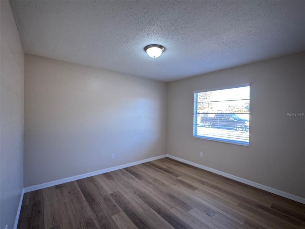 2527 Ridge Top Way Valrico, FL 33594 - Photo 20 of 31 an empty room with wooden floor and windows