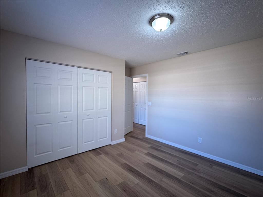 2527 Ridge Top Way Valrico, FL 33594 - Photo 21 of 31 an empty room with wooden floor and windows