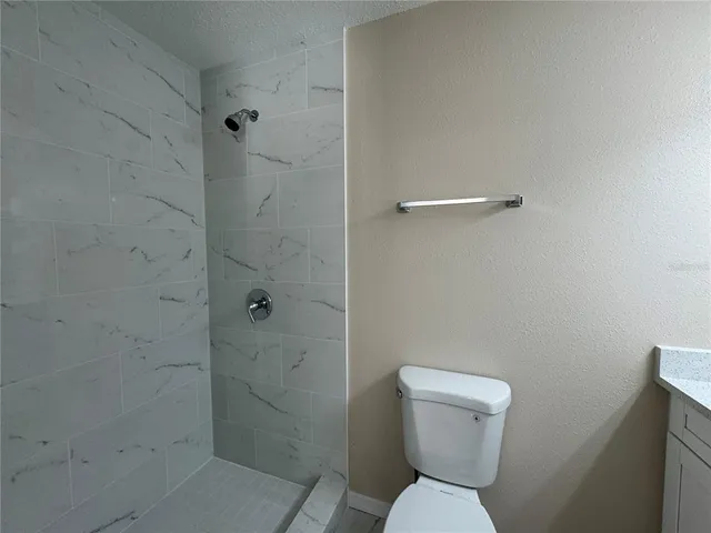 a bathroom with a toilet and a shower