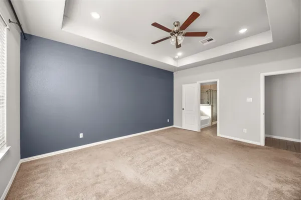 a view of a livingroom with a ceiling fan and window