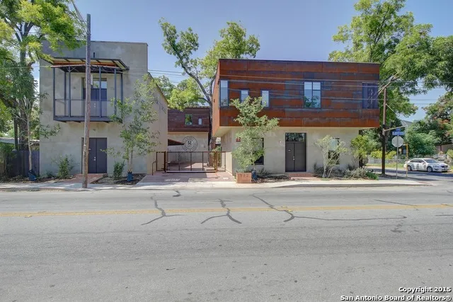 front view of a house with a potted plant on both side of it