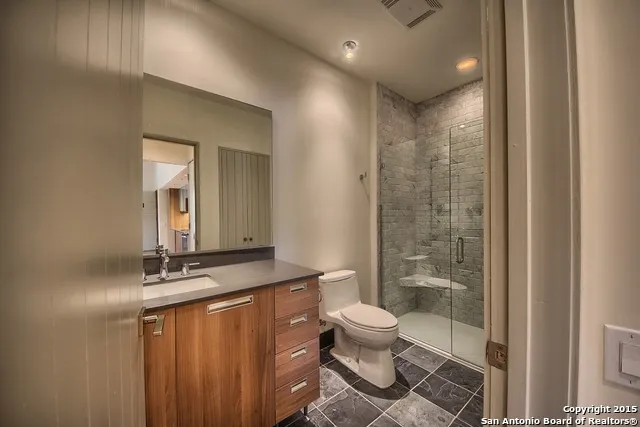a bathroom with a toilet a sink and shower