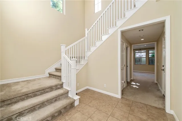 a view of entryway and hall with a floor to ceiling window