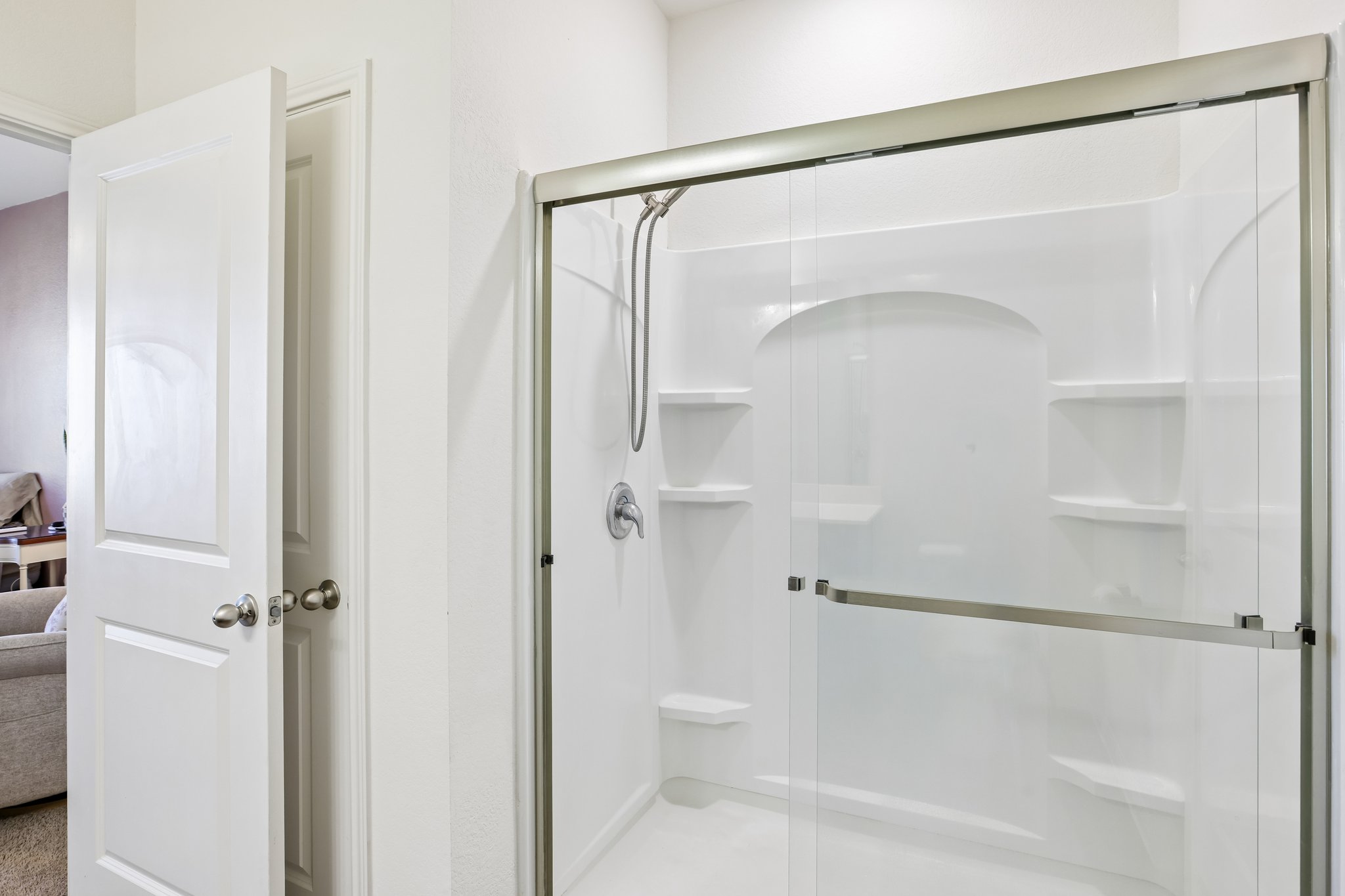 19105 Mike Mansfield Road Manor, TX 78653 - Photo 15 of 28 Built in surround shower with shelving and sliding glass door
