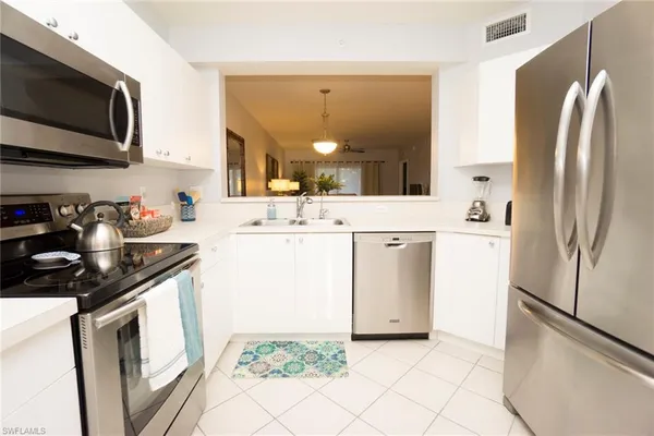 a kitchen with a sink stove and refrigerator