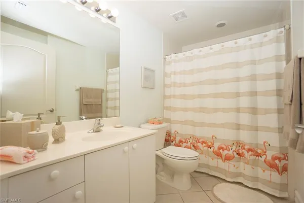 a bathroom with a sink mirror and toilet