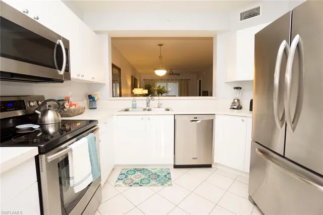 a kitchen with a sink stove and refrigerator