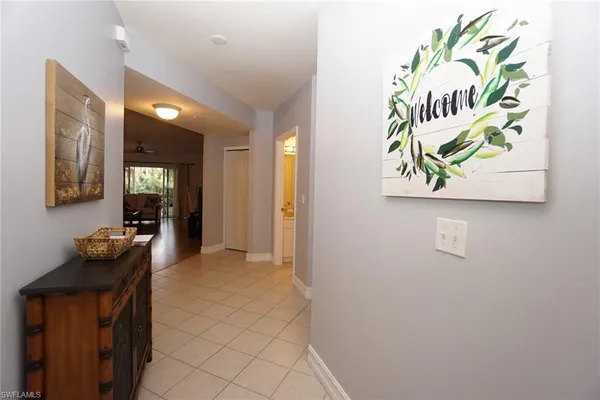 a view of hallway with furniture and wooden floor