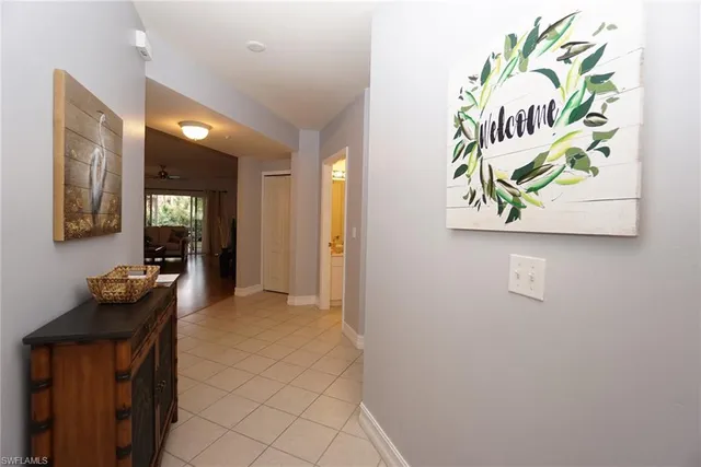 a view of hallway with furniture and wooden floor