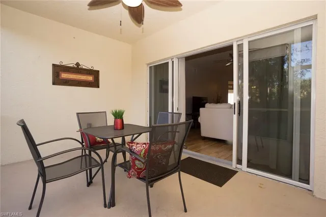 a balcony with table and chairs