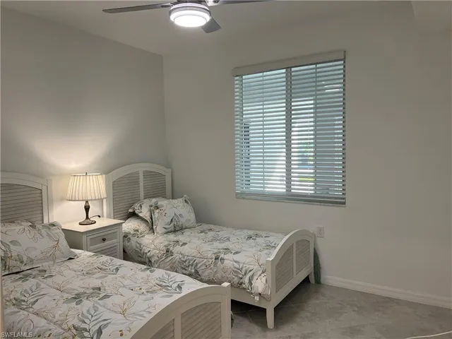 a bedroom with two beds and a window