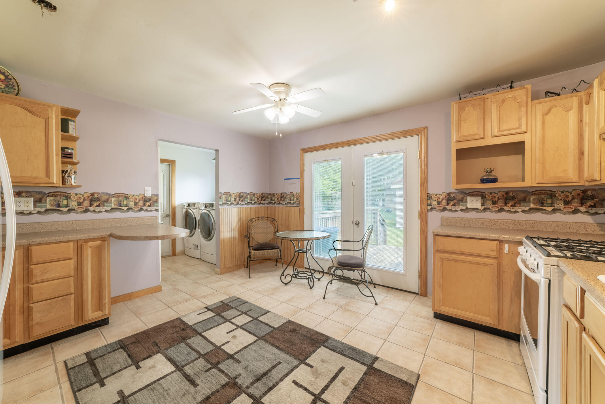 631 Osage Road Valparaiso, IN 46385 - Photo 4 of 14 a open kitchen with stainless steel appliances granite countertop a stove a sink dishwasher and white cabinets with wooden floor