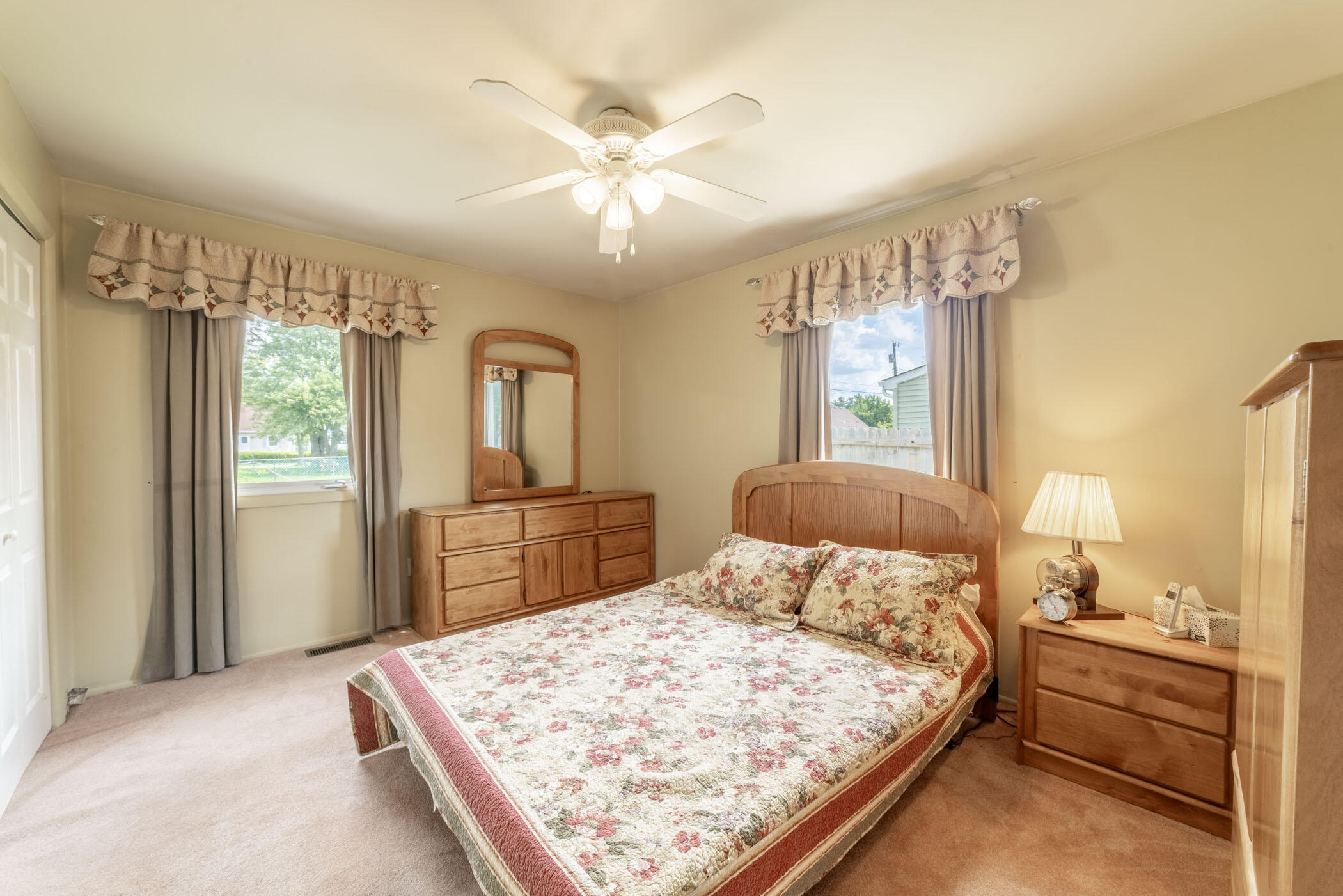 631 Osage Road Valparaiso, IN 46385 - Photo 6 of 14 a bedroom with a large bed and a chandelier