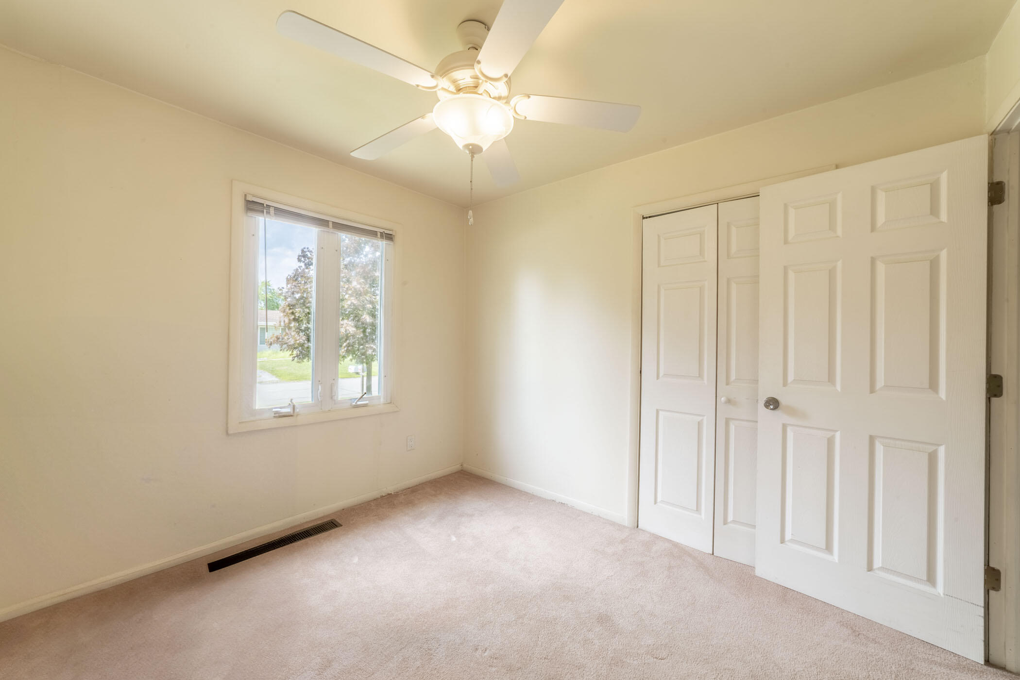 631 Osage Road Valparaiso, IN 46385 - Photo 8 of 14 an empty room with windows and fan