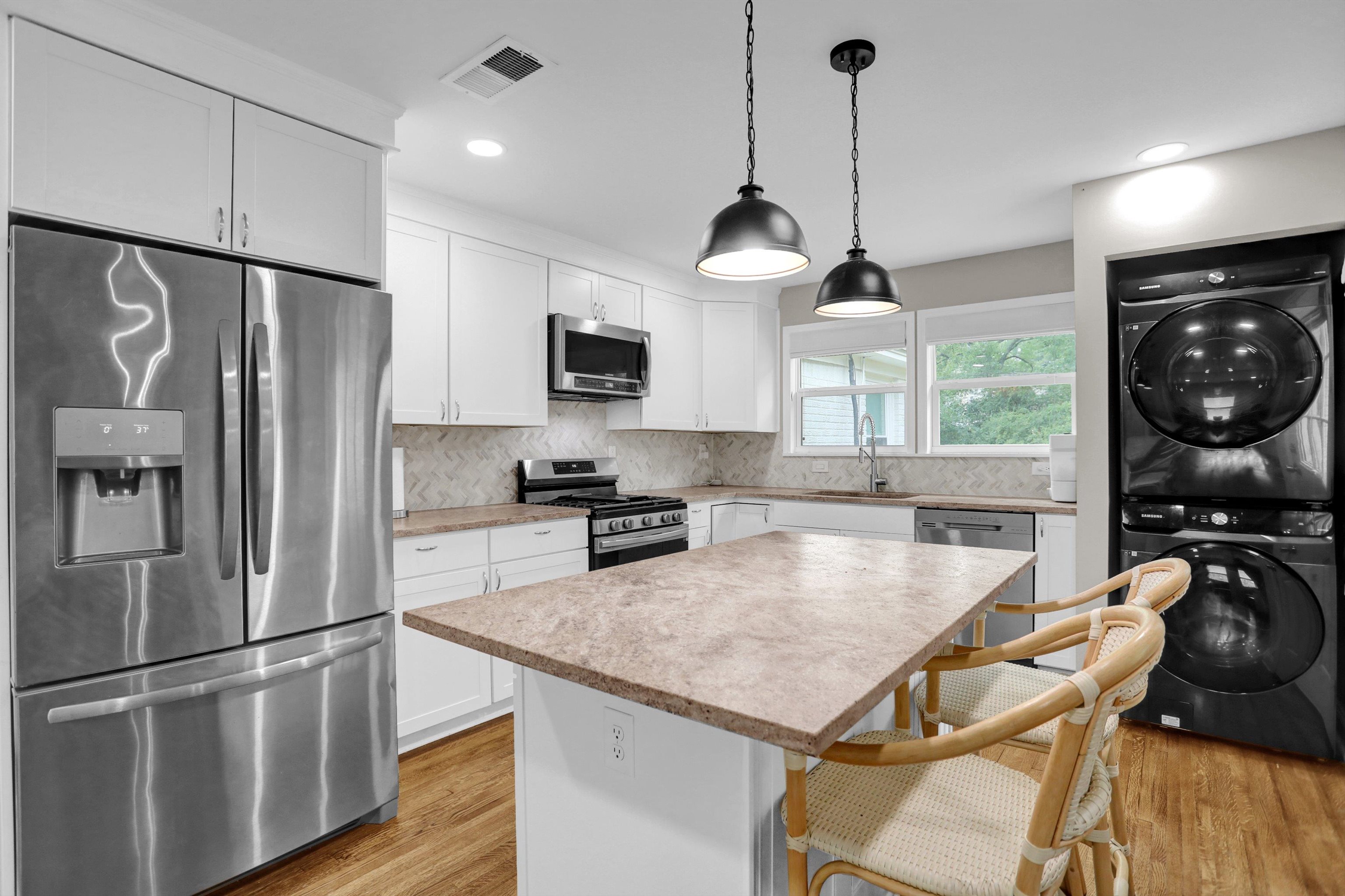 4344 Rhodes Avenue Memphis, TN 38111 - Photo 16 of 31 a kitchen with stainless steel appliances granite countertop a sink a stove and a refrigerator
