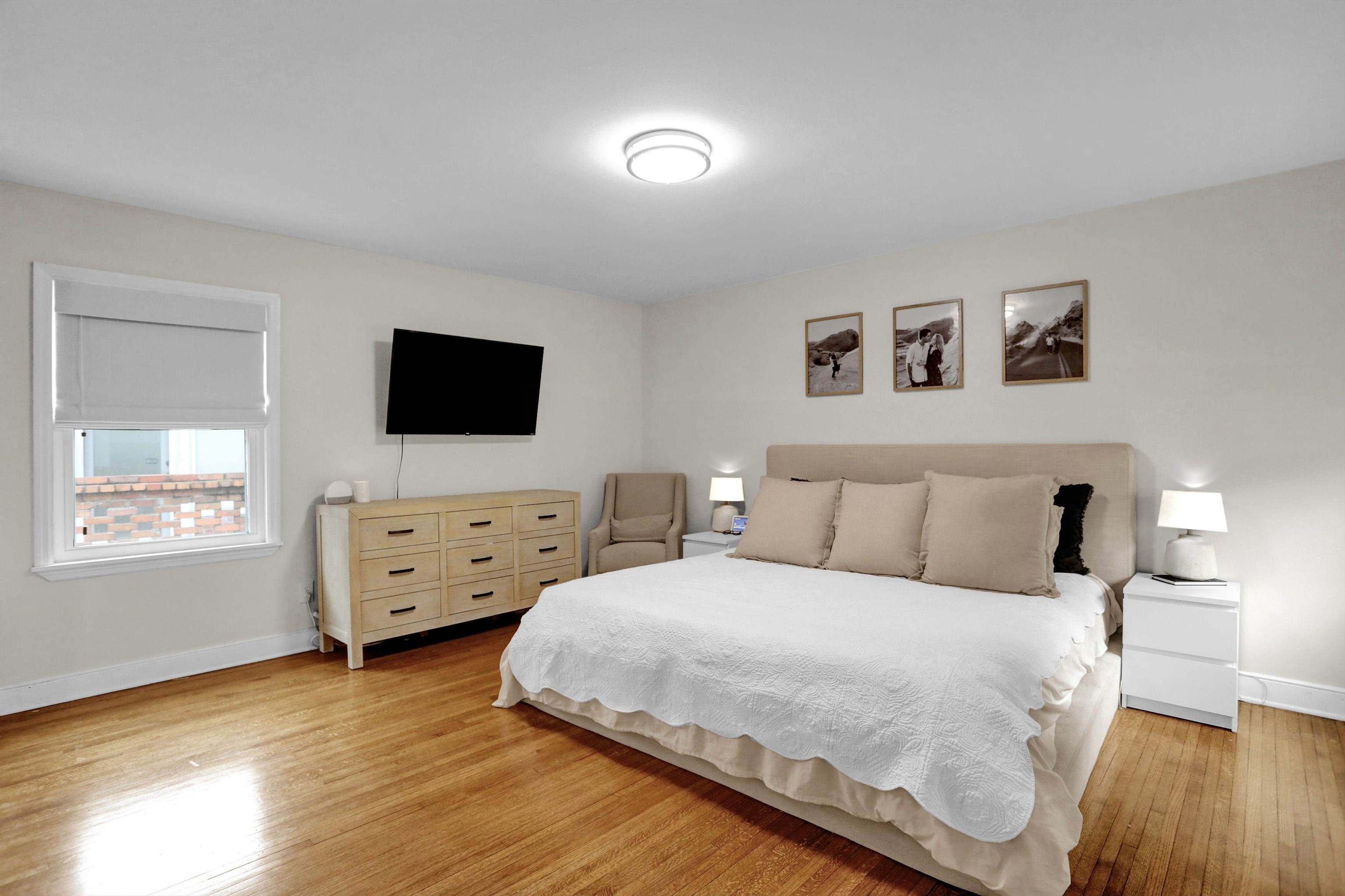 4344 Rhodes Avenue Memphis, TN 38111 - Photo 18 of 31 a room with a bed and flat tv screen on the dresser